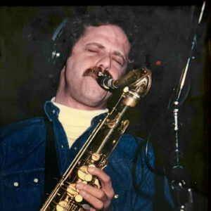 Allan playing saxophone in a session