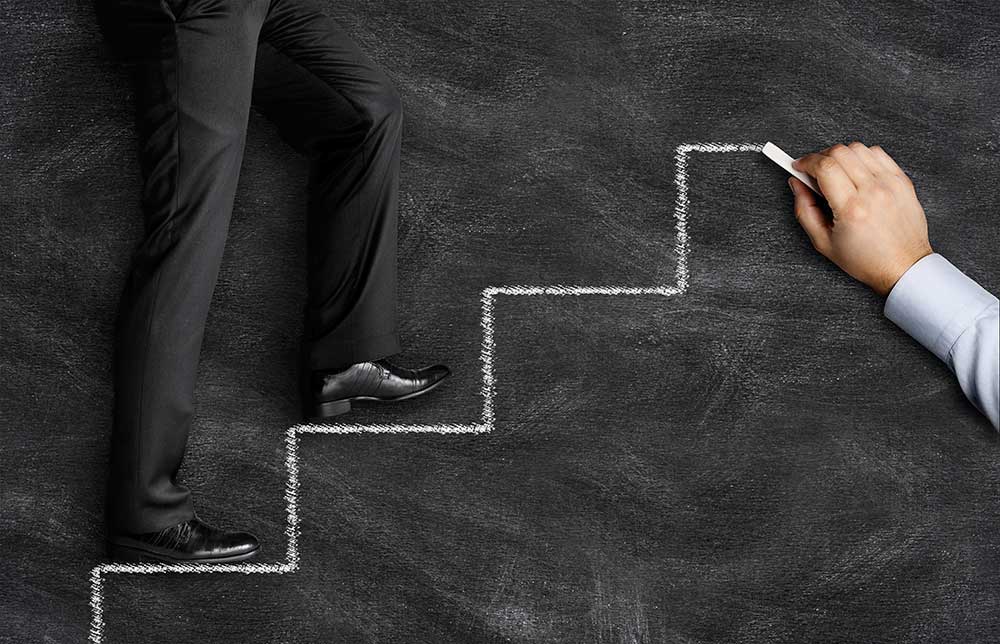 stepping stones on chalkboard